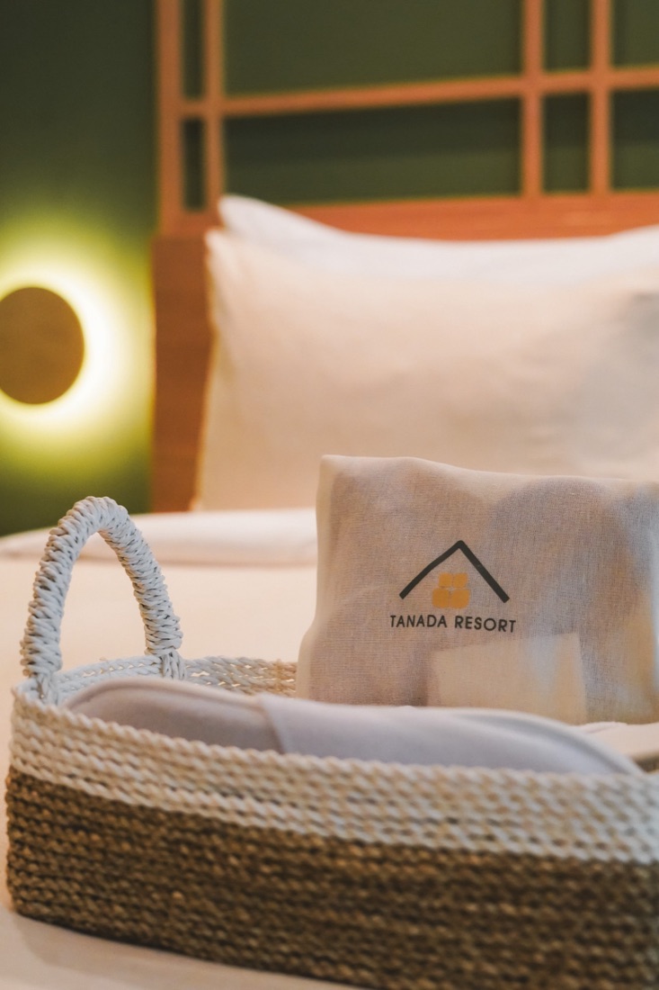 Woven amenity basket on a hotel bed