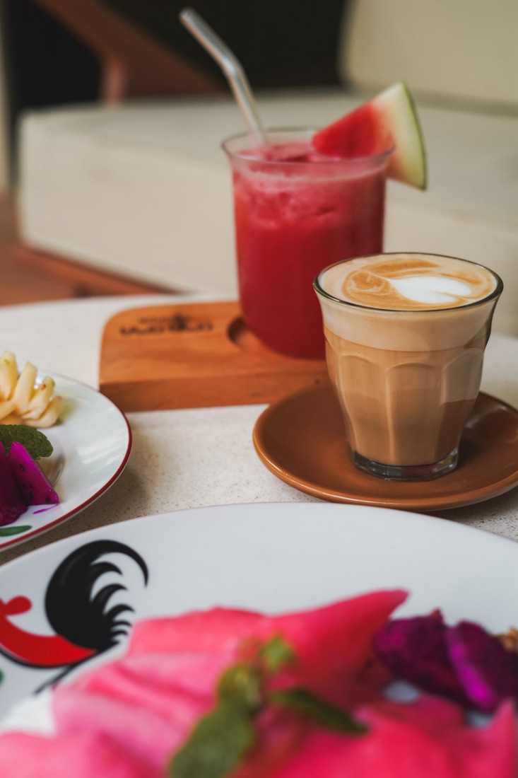 Watermelon juice and a latte on a breakfast table