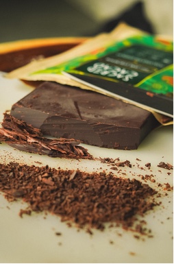 Dark chocolate bar with shavings and its wrapper